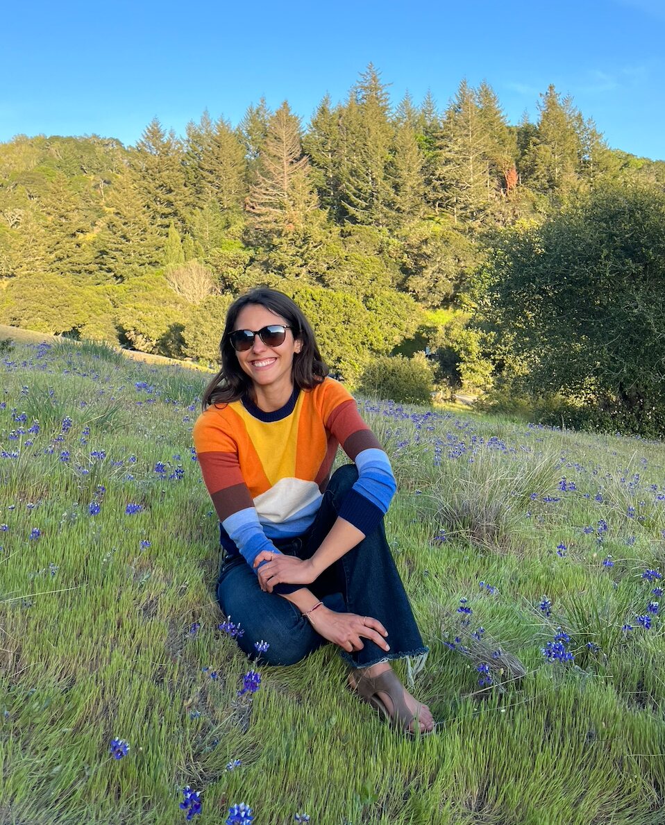 Holly Brinkman sitting in a wildflower meadow